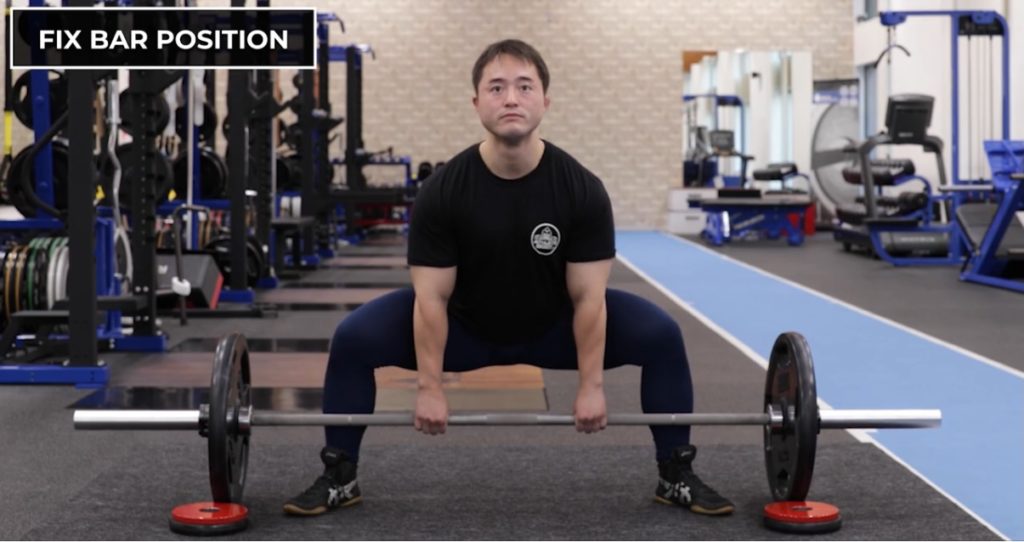 Fixing the deadlift bar position with plates will help prevent the bar from rolling forward and help you to properly use your glutes and hamstrings.